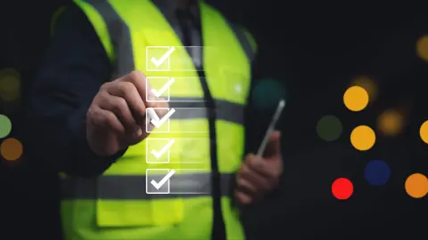 Engineer verifying a digital checklist on a construction site Safety inspection process enhances project quality and operational standards