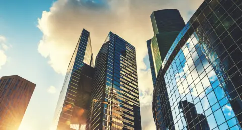 Worm's eye view of high-rise buildings with reflective glass