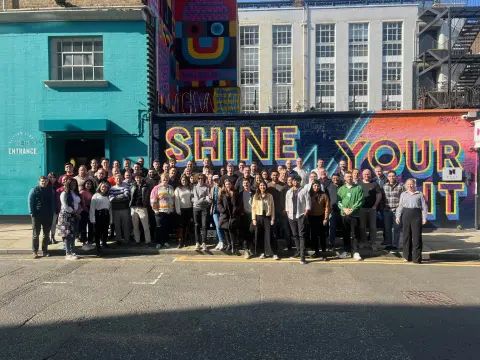 Zutec employees all gathered outside for a photograph in front of colourful building