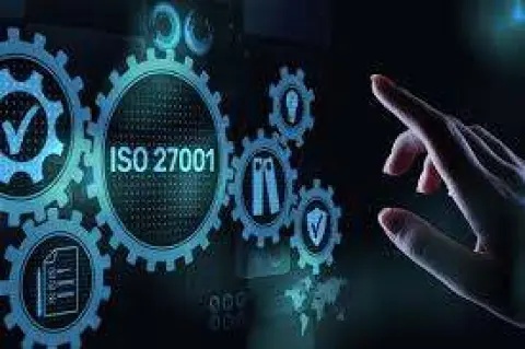 Concept of ISO 27001 information security showing cogs on a screen with a finger touching it
