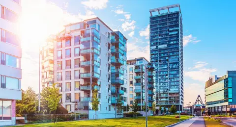New build development set in communal gardens set against a sunset backdrop