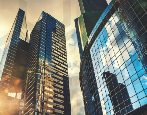 Worm's eye view of reflective styled windows on city buildings
