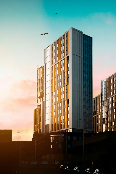 High-rise residential buildings against a sunset-lit sky