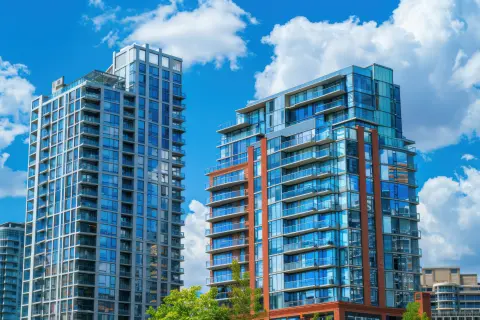 Two high rise buildings against a cloudy sky